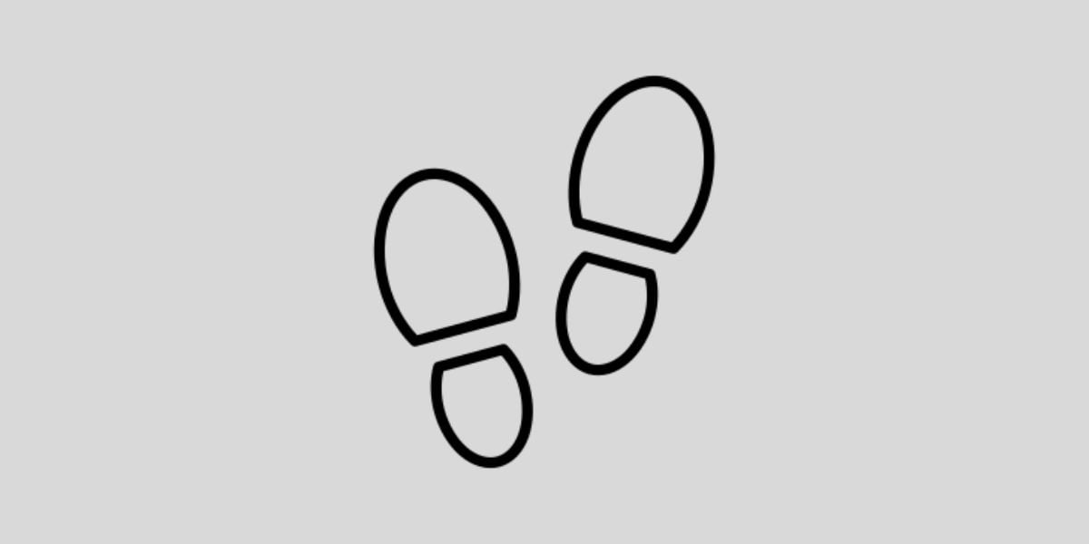 Symbol Fussabdrücke – einfache schwarze Schuhsohlen-Icons auf grauem Hintergrund